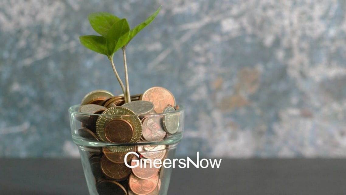 Coins in a cup with a plant growing