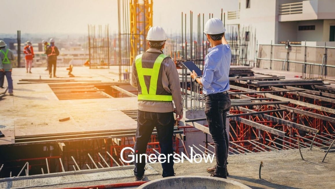two engineers at construction site discussing civil engineering subjects
